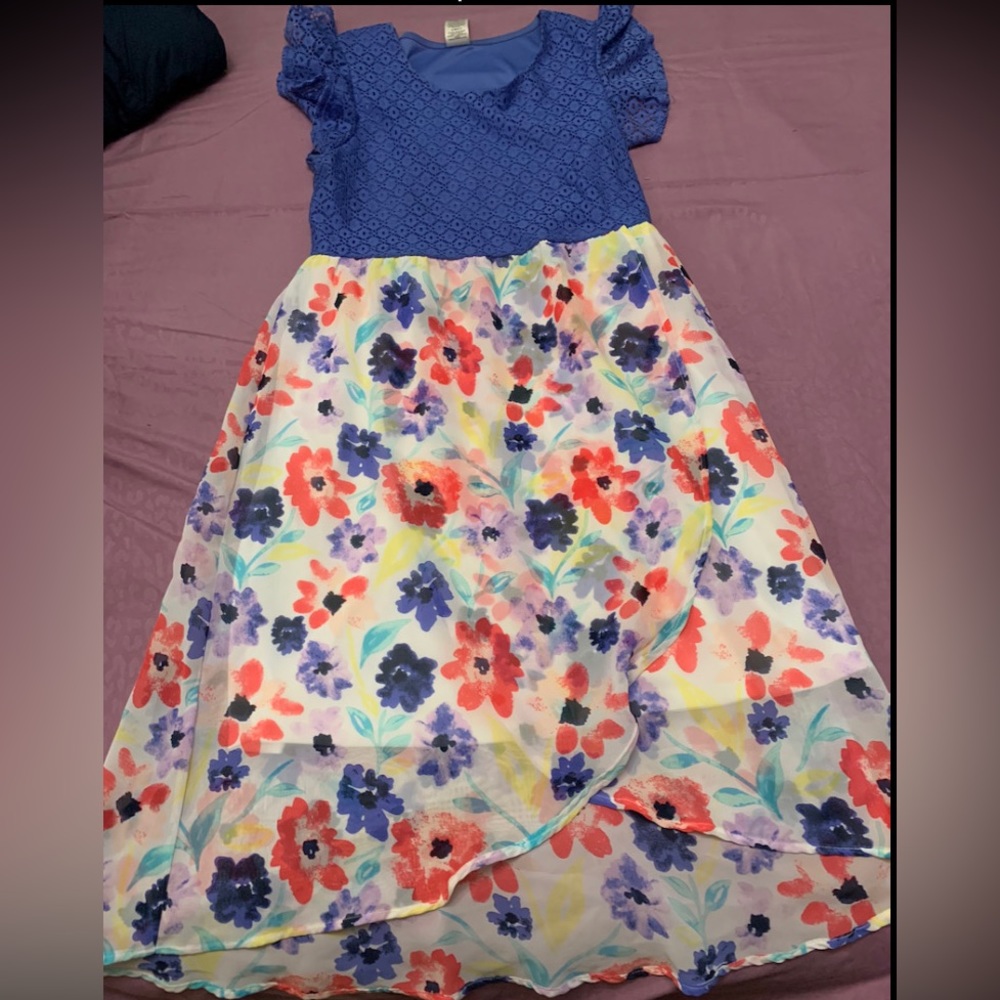 Purple in the top, flower design all around. Has a white skirt underneath.